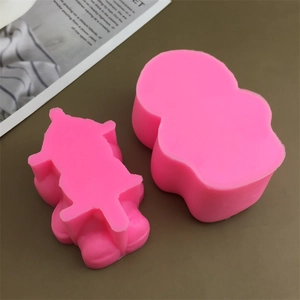 Detail of pink silicone bear mousse cake molds on a brown table with cozy home decor
