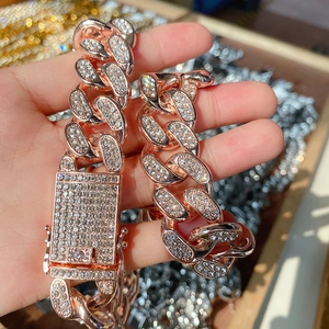 Detailed close-up of 20mm rose gold iced out Cuban link chain with square diamond clasp