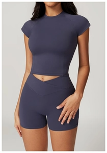 Detail view of high-waist yoga shorts featuring a unique V-shaped cross waistband design