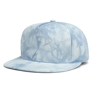 Detailed view of blue and white tie-dye cotton fabric on a flat brim baseball cap
