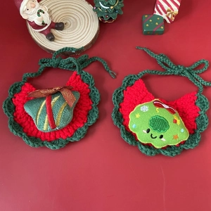 Detail of Christmas pet bibs featuring festive gift box and wreath hand-knitted patterns