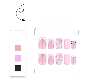 Detailed pink press-on nails set with 3D pearls, wavy patterns, and cow print designs