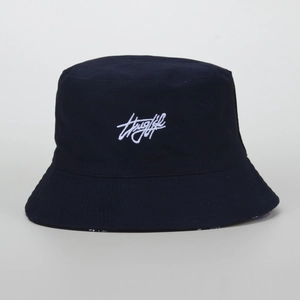 Detailed view of black canvas bucket hat featuring white Thug Life script embroidery