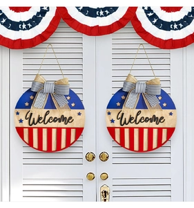 Detail of wooden 4th of July welcome signs with stars stripes and burlap bows