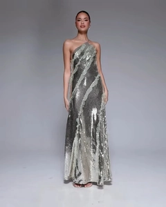 Detail of silver sequin evening gown featuring a halter neck and pale green ruffle trim