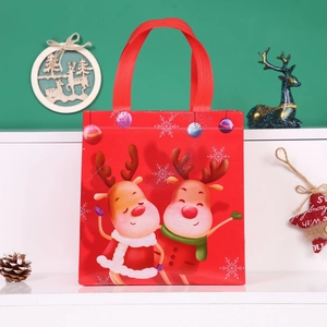 Red non-woven Christmas gift bag with cartoon reindeer prints and durable handles