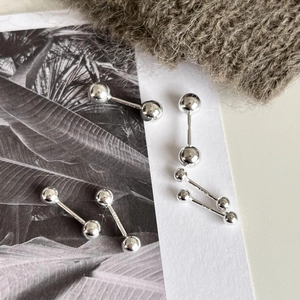 Detail showing S925 sterling silver stamp on minimalist silver bead stud earrings