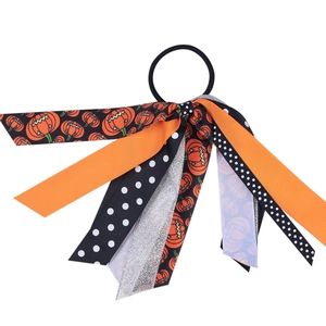 Detail of Halloween hair scrunchie with orange pumpkin ribbons and black polka dots