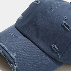 Navy blue distressed cotton baseball cap with vintage frayed edges and torn detailing