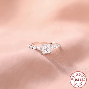 Macro shot of rose gold 925 silver ring featuring a square cut center gemstone
