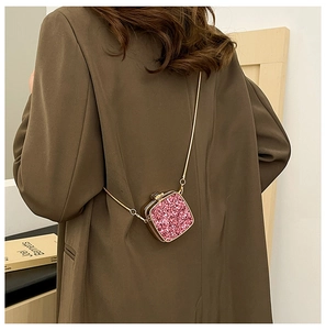 Detailed back view of pink sequin acrylic mini bag with a thin gold metal chain strap
