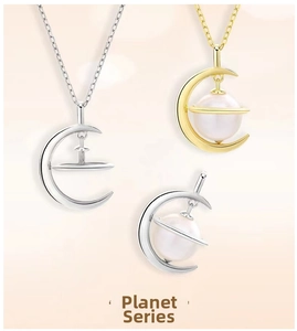 Close-up of crescent moon and planet pendants with pearls in gold and silver finishes