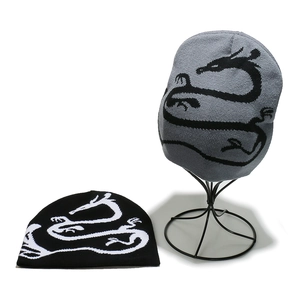 Detail of knitted beanie hats featuring dragon patterns in black and grey winter styles