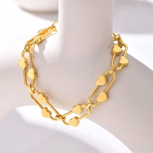 Close-up of 18K gold stainless steel chain bracelet with solid 3D heart-shaped charms