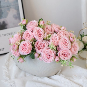 Pink artificial peonies in textured white ceramic pot for home decor and weddings