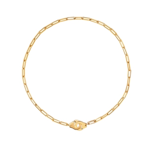 Detailed macro view of 18k gold handcuffs pendant on a paperclip style chain link