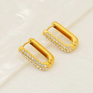 Detailed macro view of gold-plated rectangular hoop earrings with pavé cubic zirconia