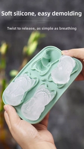 Close-up of flexible green silicone bulldog ice mold showing easy release of ice cubes