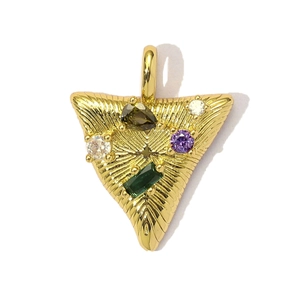Macro detail of golden triangular pendant with colorful zircon stones and metallic finish