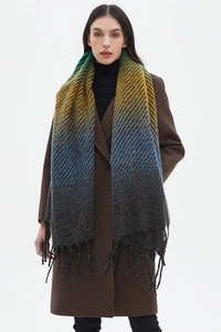Detail showing the gradient color transition and fringe texture of the woven scarf