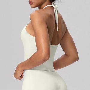 Detail view of white halter neck sports bra with open back design and elastic fabric