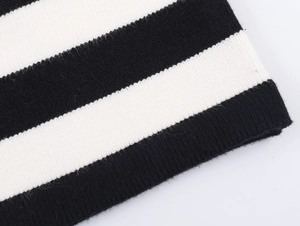 Detailed view of black and white striped knit texture on a cozy women cardigan