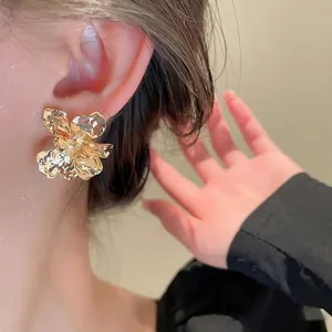 Chic golden petal-shaped flower stud earrings with a vintage metallic texture