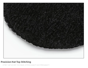 Macro shot of precise stitching and black faux fur texture on the top of the beanie