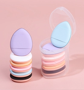 Colorful mini finger powder puffs in a transparent storage jar for precise makeup application