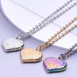 Three heart pendants in gold, silver and rainbow colors with embossed texture