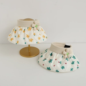Detail view of foldable shell hats with floral patterns and knitted texture accents