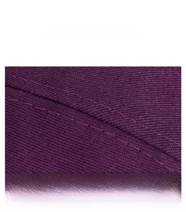 Detailed close-up of purple twill fabric texture and fine stitching on a baseball cap