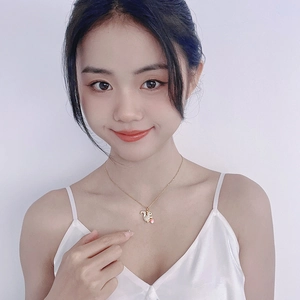 Gold squirrel necklace with pink heart and crystal pavé on Asian model's neck