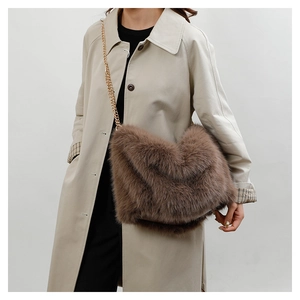 Detail shot of brown faux fur tote bag featuring a textured finish and gold metal chain strap