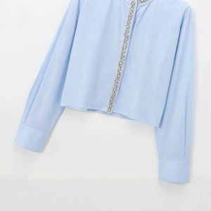 Light blue long sleeve poplin shirt with shimmering rhinestone trim on the front placket