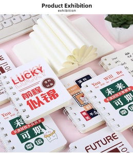 Flat lay of cute A7 spiral notebooks with cartoon rabbit covers and motivational quotes