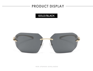Close-up of gold and black rimless sunglasses with high quality metal frame and nose bridge