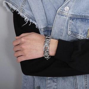 Close-up of a punk lion head bracelet in vintage titanium steel on a male model