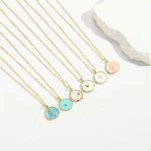 Detail of six gold enamel necklaces featuring sea horse, star, heart, and flower pendants