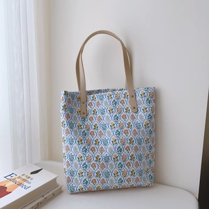 French floral cotton tote bag with leather handles and orange flower patterns