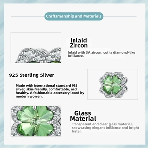 Detail of 925 sterling silver four-leaf clover charm with green glass and 3A zircon stones