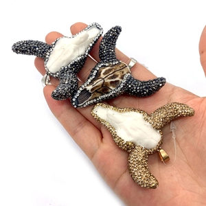 Three bull head skull pendants with rhinestones in white and brown marble acrylic