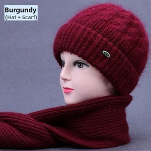 Detail of wine red knitted hat and scarf set for elderly women with metal accent