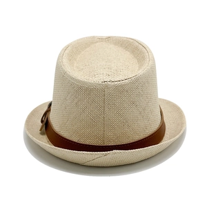Close-up of finely woven straw hat texture with brown leather belt buckle detail