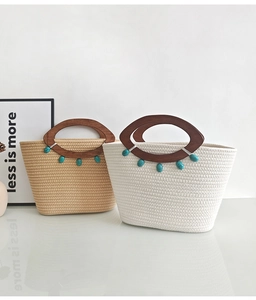 Detail of khaki and beige woven tote bags featuring unique oval wooden handles and beads