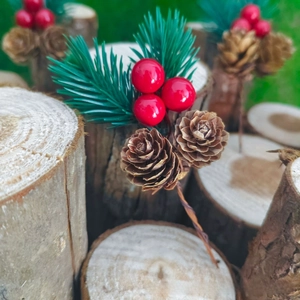 Macro detail of artificial pine needles with red berries and mini natural pine cones for DIY