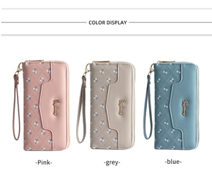 Detail view of quilted long wallets for women in pink, grey and blue colors