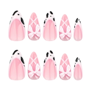 Pink cow print press-on nails with 3D bows and almond cross stripes manicure set