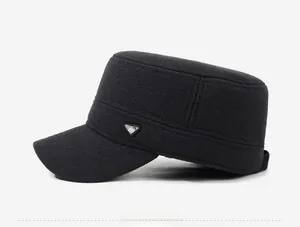 Detail view of winter woolen flat cap featuring side metal triangle logo and textured fabric
