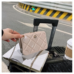 Detail view of beige quilted PVC mini bag with gold chain and rose buckle detail